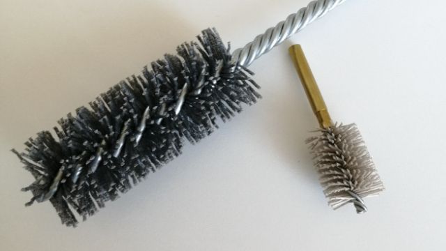 Bristle material containing abrasive grains